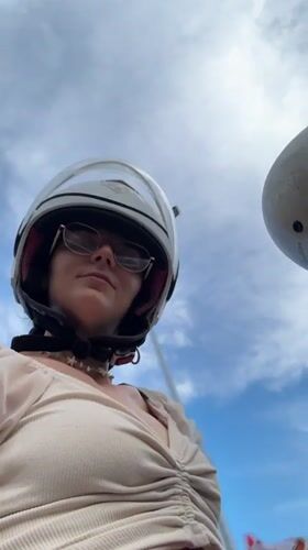 Woman rides motor scooter with passenger in Vietnam