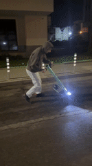 Man rides electric scooter on Sofia street at night