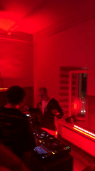 Late-night DJ session in red-lit Moscow room