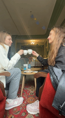 Two women share coffee and toast at Kryvyi Rih cafe