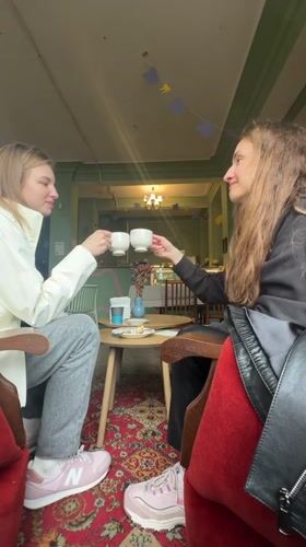 Two women share coffee and toast at Kryvyi Rih cafe