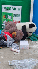 Stuffed animals among discarded items near recycling bins