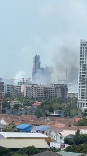 Smoke spotted rising behind buildings in Pattaya skyline