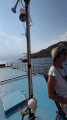 Boat approaches green island off Nha Trang under sunny skies