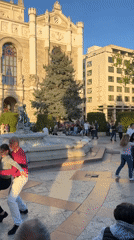 Couples dance salsa at Budapest public plaza fountain