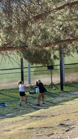 Couple dances in Los Angeles park near recreational area