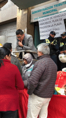 Crowds gather at La Paz tax office with guards present