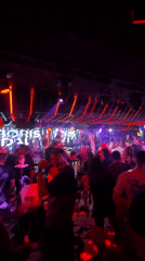 Nightclub scene captured in Sofia with neon lights, crowds