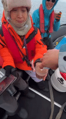 Antarctic boat passengers share drinks amid icebergs