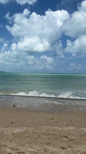 Calm morning at a Bang Muang beach, waves, clouds, and lounging.