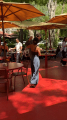 Morning social gathering at red-themed outdoor cafe in Yerevan