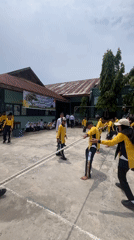 Tug-of-war competition in Lhokseumawe, two uniformed teams pulling hard