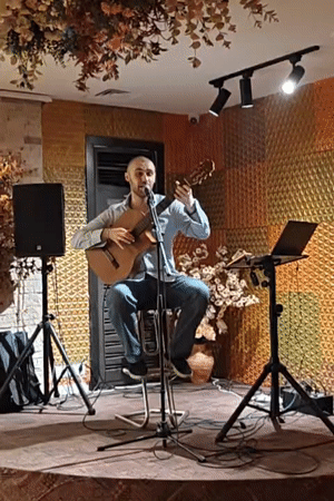Solo acoustic guitar performance on a Tbilisi stage