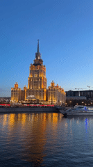 Moscow Hotel Glows Golden at Dusk, Reflects on River