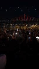 Late-night crowd parties outdoors in Montreal under string lights