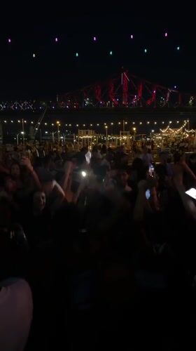 Late-night crowd parties outdoors in Montreal under string lights