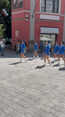 Majorettes parade through Plovdiv town square with drummers