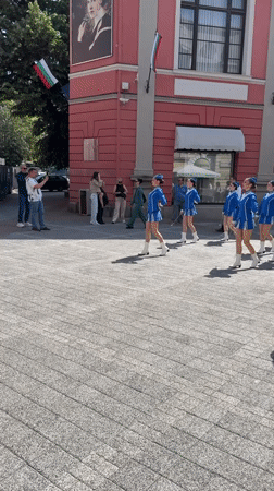 Majorettes parade through Plovdiv town square with drummers
