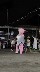 Nighttime street carnival with costumed performers in Buenos Aires