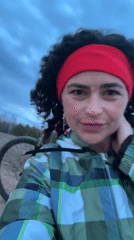 Woman poses with mountain bike in rural Russia