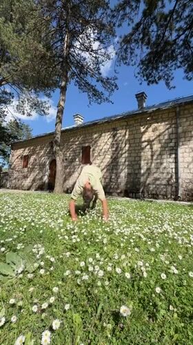 People pick daisies, play in field near Cetinje church