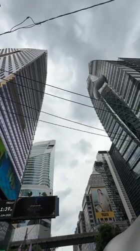Bangkok morning commute captured from street level during overcast conditions