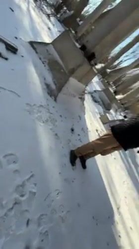 Visitor documents exploration of Pripyat cooling tower in snow