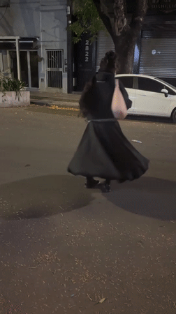 Woman spins in circles on Buenos Aires street