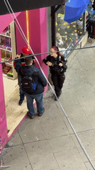 Police officer speaks with two men on Buenos Aires sidewalk