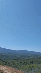 Wind turbines dot mountain landscape in morning video