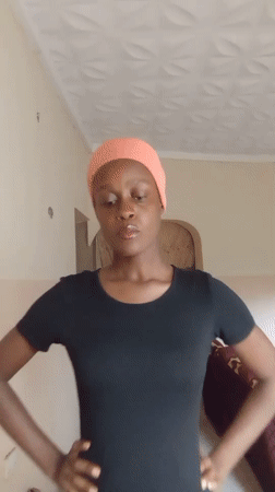 Woman poses for selfies, gestures indoors in Akwanga Nigeria