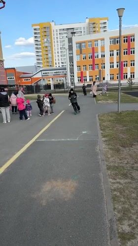 Boy plays with scooter at Tobolsk playground on sunny day