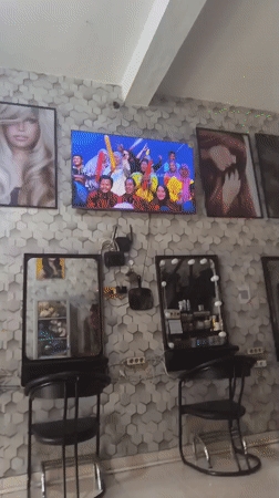 Inside a North Jakarta hair salon with a game show on TV