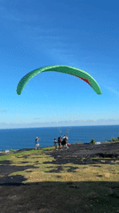 Paragliders launch from clifftops near Kutuh, Indonesia coastline