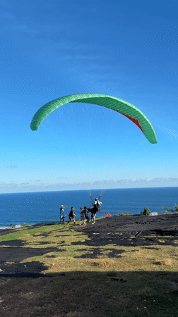 Paragliders launch from clifftops near Kutuh, Indonesia coastline