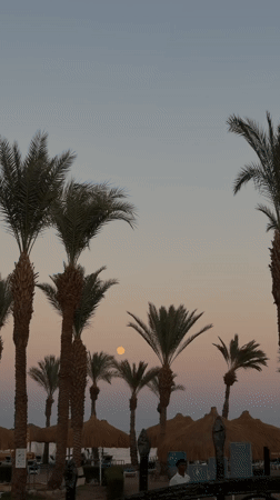 Full moon rises over a Sharm El Sheikh resort at dusk