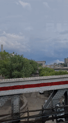 Train passenger films Paris cityscape view with river