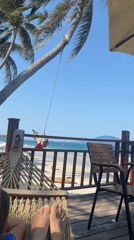 Woman enjoys peaceful hammock afternoon at beachside deck