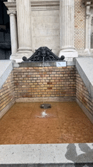 Ornate fountain and stone lion sculpture documented in Budapest