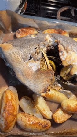 Home cook prepares whole fish dinner in Even Yehuda