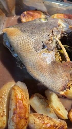 Home cook prepares whole fish dinner in Even Yehuda