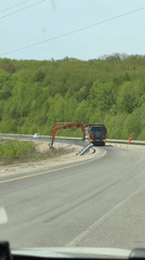 Dump truck transports excavator arm on Russian highway