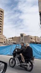 Building debris documented behind blue tarp in Tehran