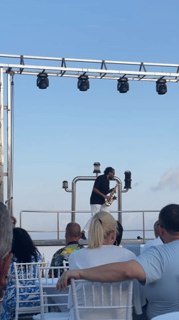 Paphos waterfront evening: pier portraits and live saxophone