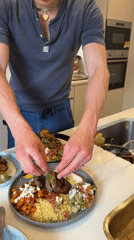 Young man prepares Mediterranean meal in London kitchen