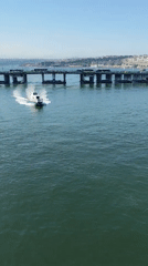 Small boat passes under bridge in Istanbul waters