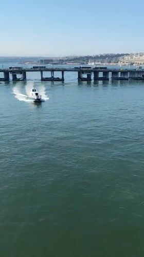 Small boat passes under bridge in Istanbul waters