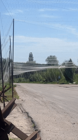 Anti-tank defenses, camouflage netting observed on Ukrainian rural road