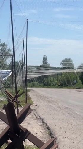 Anti-tank defenses, camouflage netting observed on Ukrainian rural road