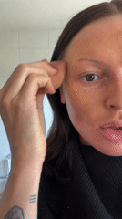 Woman demonstrates skincare routine in Langton Green bathroom